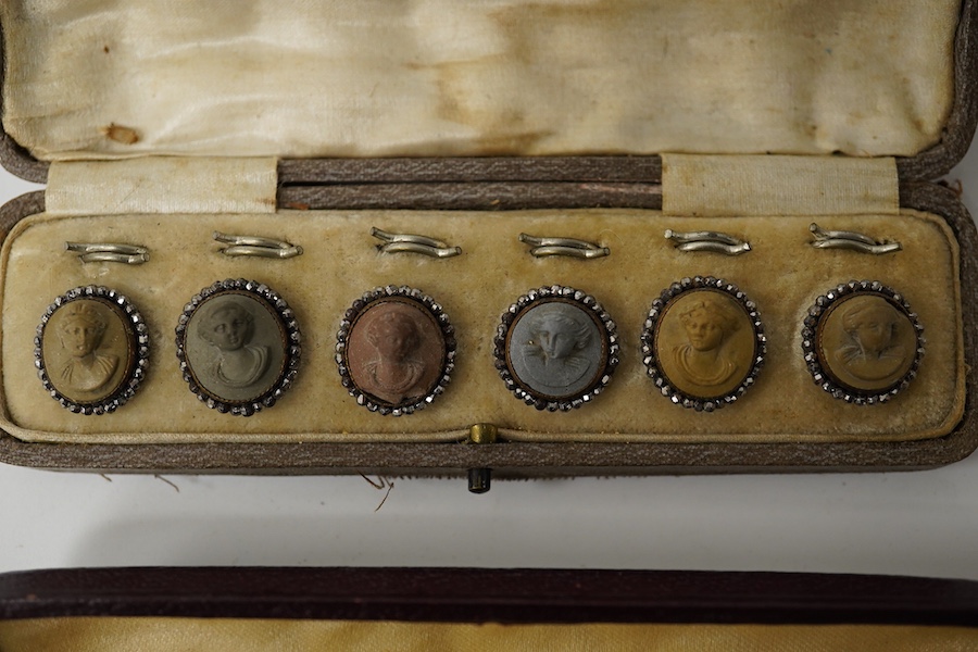 A cased set of 6 late Victorian carved lava buttons with cut steel borders, each carved with a classical female bust, 16mm and a cased set of 6 mother of pearl dress studs with gilt backs., Condition - cut steel border t